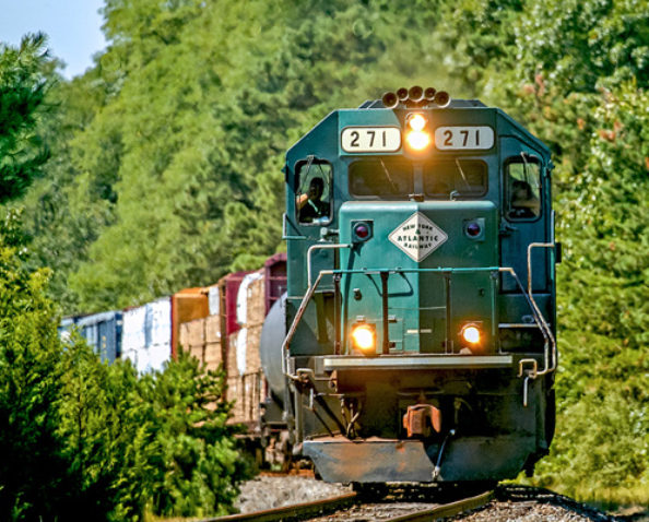 New York & Atlantic Railway train coming around a bend