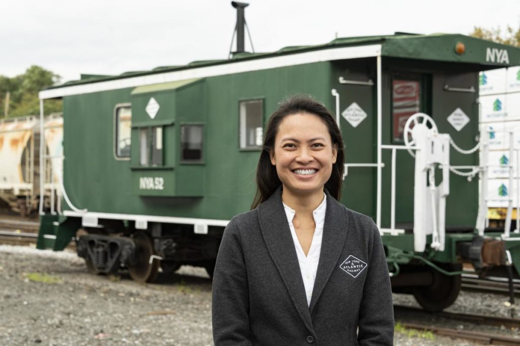 Amy Louk posing with NYA railcar