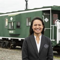 Amy Louk of the NYA posing with NYA railcar