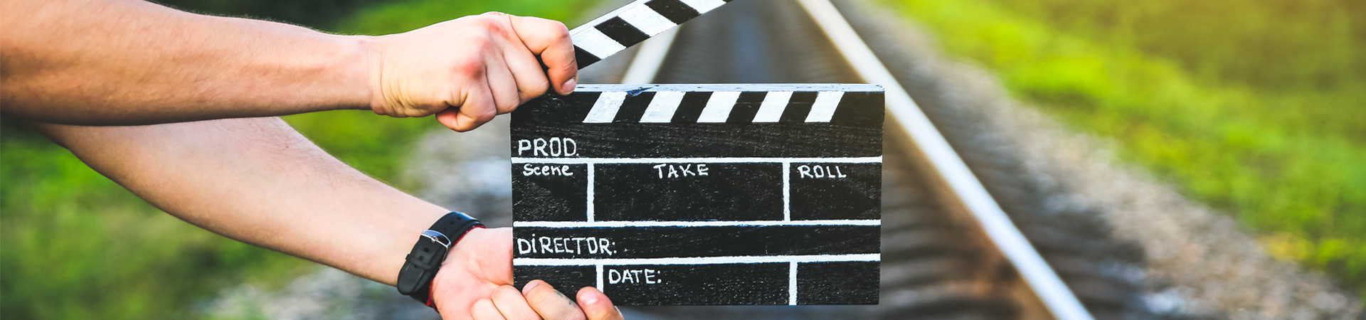 A man holding a film slate